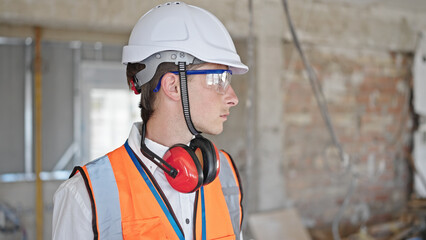 Young caucasian man architect standing with relaxed expression at construction site