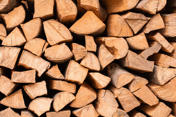 Textured firewood background, stack of chopped wood