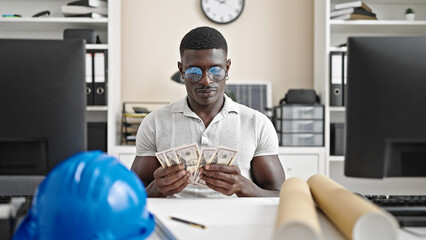 African american man architect counting dollars thinking at the office