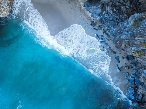Drone top down aerial view of a beach with clear sea water and rocks at Mylopotamos Greece summer_7