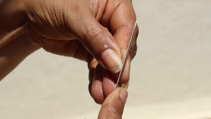 Nails manicure with file, Woman nail caring at home. Close-up of a filing nails by herself, self caring - Powered by Adobe