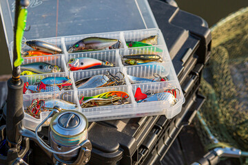 A large fisherman's tackle box fully stocked with lures and gear for fishing.fishing lures and accessories. fishing spinning. Kit of fishing lures.