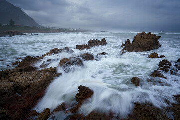 Fototapeta na wymiar Rough seas and stormy skies as a winter cold front moves past Hermanus, Whale Coast, Overberg, Western Cape, South Africa.