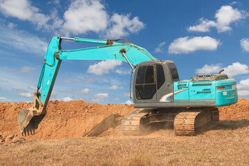Crawler Excavator digging the soil In the construction site with cloud sky background