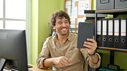 Young hispanic man business worker make selfie by touchpad at office