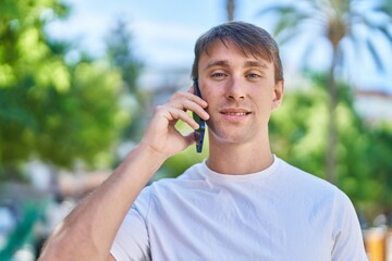 Fototapeta premium Young caucasian man smiling confident talking on the smartphone at park