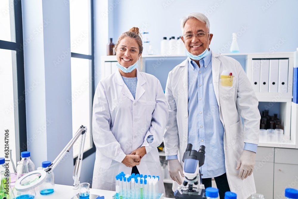 Canvas Prints Middle age hispanic people working at scientist laboratory with a happy and cool smile on face. lucky person.