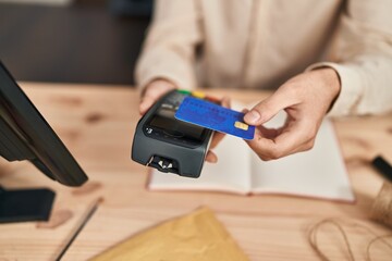 Young caucasian man ecommerce business worker using data phone and credit card at office