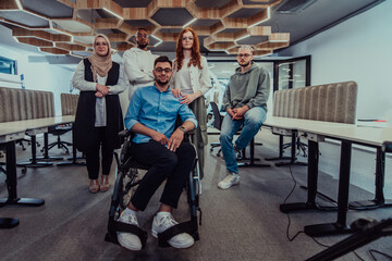 Fototapeta na wymiar Young businessmen in a modern office extend a handshake to their business colleague in a wheelchair, showcasing inclusivity, support, and unity in the corporate environment.