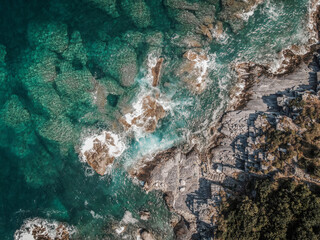 Drone top down aerial view of a beach with clear sea water and rocks at Mylopotamos Greece summer_2