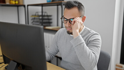 Hispanic man business worker using computer wearing glasses at office