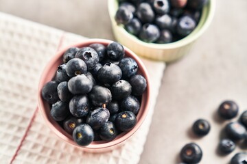  Delicious group of blueberries on ceramic bowls marble surface