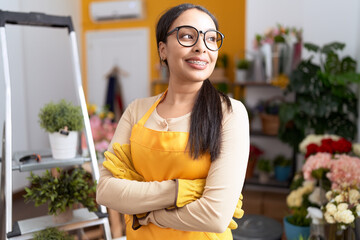 Young arab woman florist smiling confident standing with arms crossed gesture at flower shop