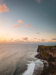 Nusa Penida, Bali, Cliff, Blue water. Exotic, vacation. Explore Indonesia. Sunset and pink sky. 