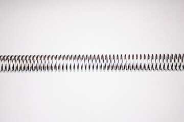 Steel spring. Spring tension. Spring made of steel on a white background.