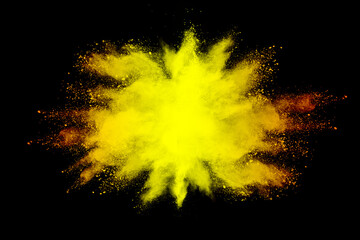 abstract powder splatted background. yellow powder explosion on black background. Colored cloud....