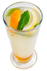 Lemonade with lemon slices and mint in a tall glass. Yellow cocktail with citrus