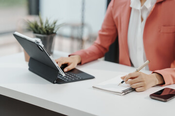 Fototapeta premium Excited Asian business woman secretary working with product liability, Scarcity, Negotiate, Proposal, Advertising Cost & How to Buy Ads on Any Budget, Interest rate, Dividend, Demand, Remuneration