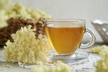 A cup of herbal tea with elderberry flowers