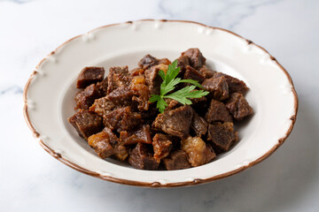 Muslims Traditional Sacrifice holiday food lamb, Turkish roasted meat in copper pot on table top. Turkish Kavurma. (Turkish name; Kurban kavurma)