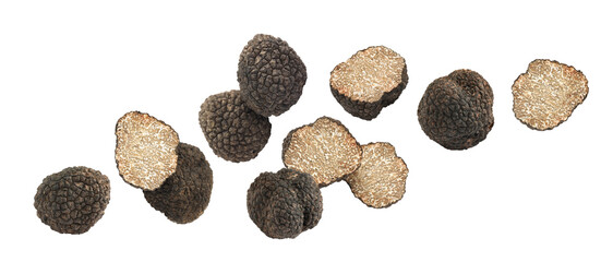 Cut and whole truffles falling on white background