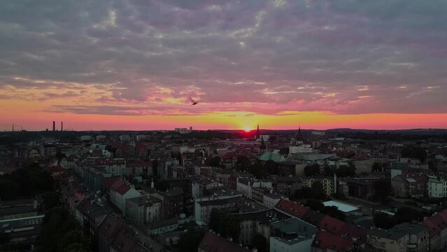 Sunset landscape in city. old European city, evening. aerial view. birds in sun rays. seamless drone video. Panoramic background for relaxing and meditation on sun. Silesian city. Bytom.