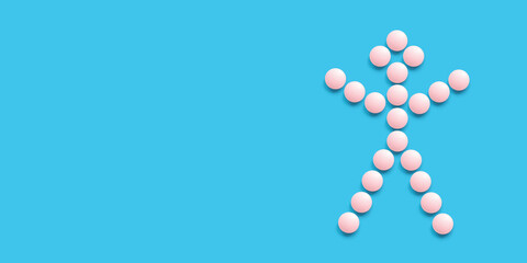 A little man lined with pink pills on a blue background, top view. Health care, medical pills and nutritional supplements. Pharmaceuticals and drug abuse