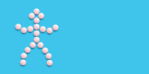 A little man lined with pink pills on a blue background, top view. Health care, medical pills and nutritional supplements. Pharmaceuticals and drug abuse