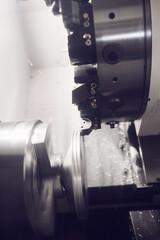 Numerically controlled machine with a revolver head grinds a metal element. Cutting groove of...