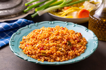 Traditional turkish bulgur pilaf with tomato sause in plate (Turkish name; meyhane pilavi)