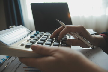 Unrecognizable businessman using calculator