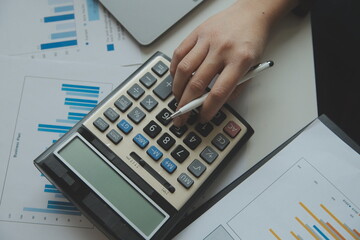 Unrecognizable businessman using calculator