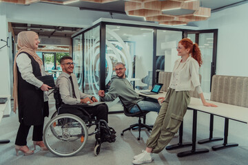 Young group of business people brainstorming together in a startup space, discussing business...