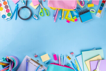 School equipment high-colored bright blue flat lay. Various school education and office supplies, accessories. Back to school sale background top view copy space