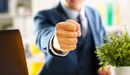 Male clenched fist in suit at office closeup. Aggressive career strategy angry negotiation strong...
