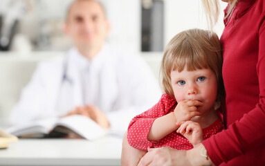 Little child with mother at pediatrician reception. Physical exam cute infant portrait baby aid...