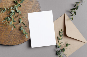 Invitation or greeting card mockup with envelope and natural eucalyptus decor, blank mock up with copy space