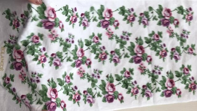 The woman makes a brown tange after the purchase. Lays on the table. Close-up. Vertical video.