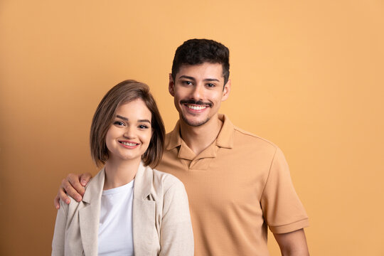 Happy Couple Smiling And Looking At Camera In All Beige Colors. Portrait, Real People Concept.