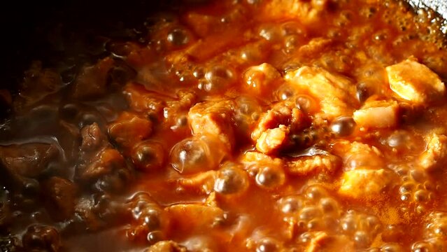 Stewing chopped pork with sauce in pan, in door  Chiangmai  Thailand.