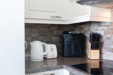 White kitchen counters in the kitchen with modern home kitchen equipment