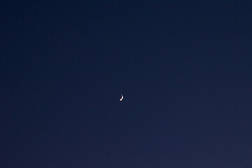 bright moon between the buildings at night and in the morning