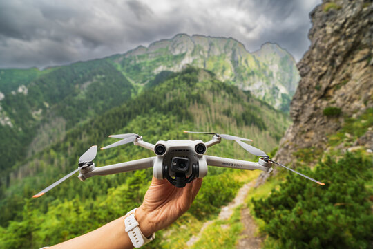 Poland, Zakopane August 5, 2023.  Drone dji mini 3 pro in a female hand against the backdrop of the Tatra mountains.