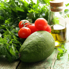 fresh avocado and greens on wooden background