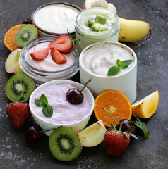 various yogurts with fresh berries and fruits