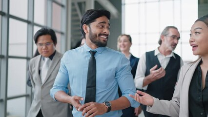 Group of diverse business people talking while walking together at modern office. Group of diverse coworkers discussion while walking the corridor in office together. Multiethnic business people group