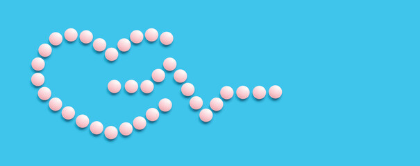 A group of pink round pills form a heart shape on a blue background. Pulse. The theme of...