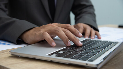 Businessman working at office with digital tablet, laptop computer, smart phone. Professional investor connection internet application online. Businessman review annual company report.