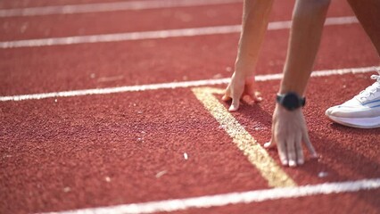 Hands runner ready start to run athlete sportsman training run on lane at the stadium in morning. Runner man wearing white vest to practice running prepare for competition race.