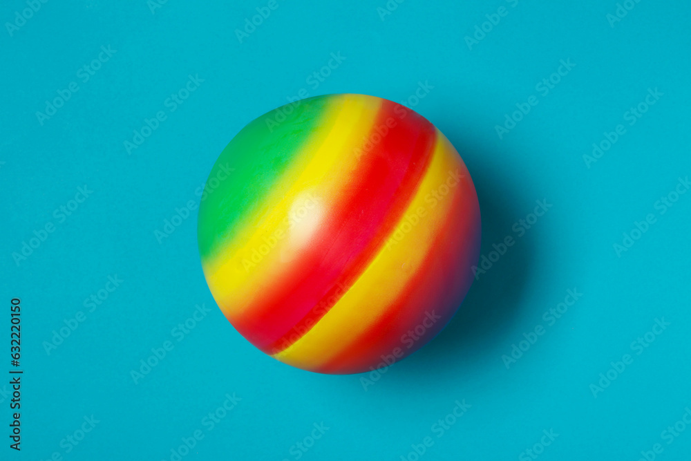 Poster New bright kids' ball on light blue background, top view